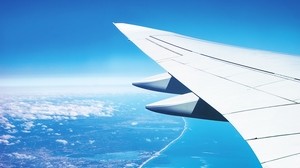 airplane wing, top view, city, flight, ocean