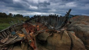 the remains, boat, frame, stones, cloudy